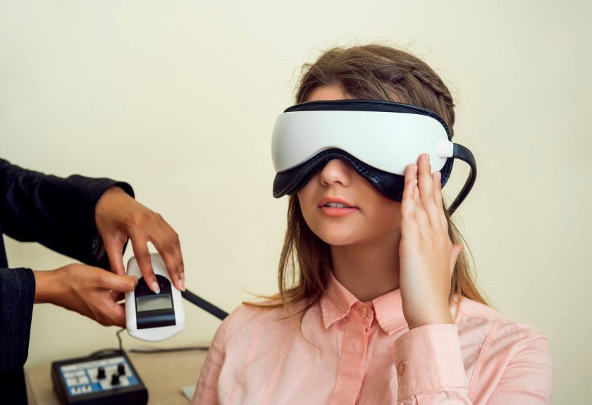 girl is worried her sight relaxed modern european woman sitting office eye care specialist waiting when procedure will be finished wearing digital vision screener during check up
